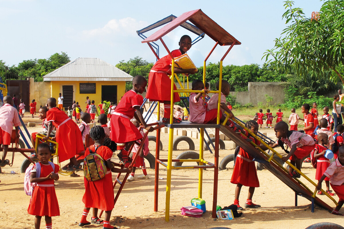 African children play on a slide in a kindergarten in Nigeria. The project is called For Smiling Children. This is supported by the Grand Resort Bad Ragaz. A star hotel in Switzerland.