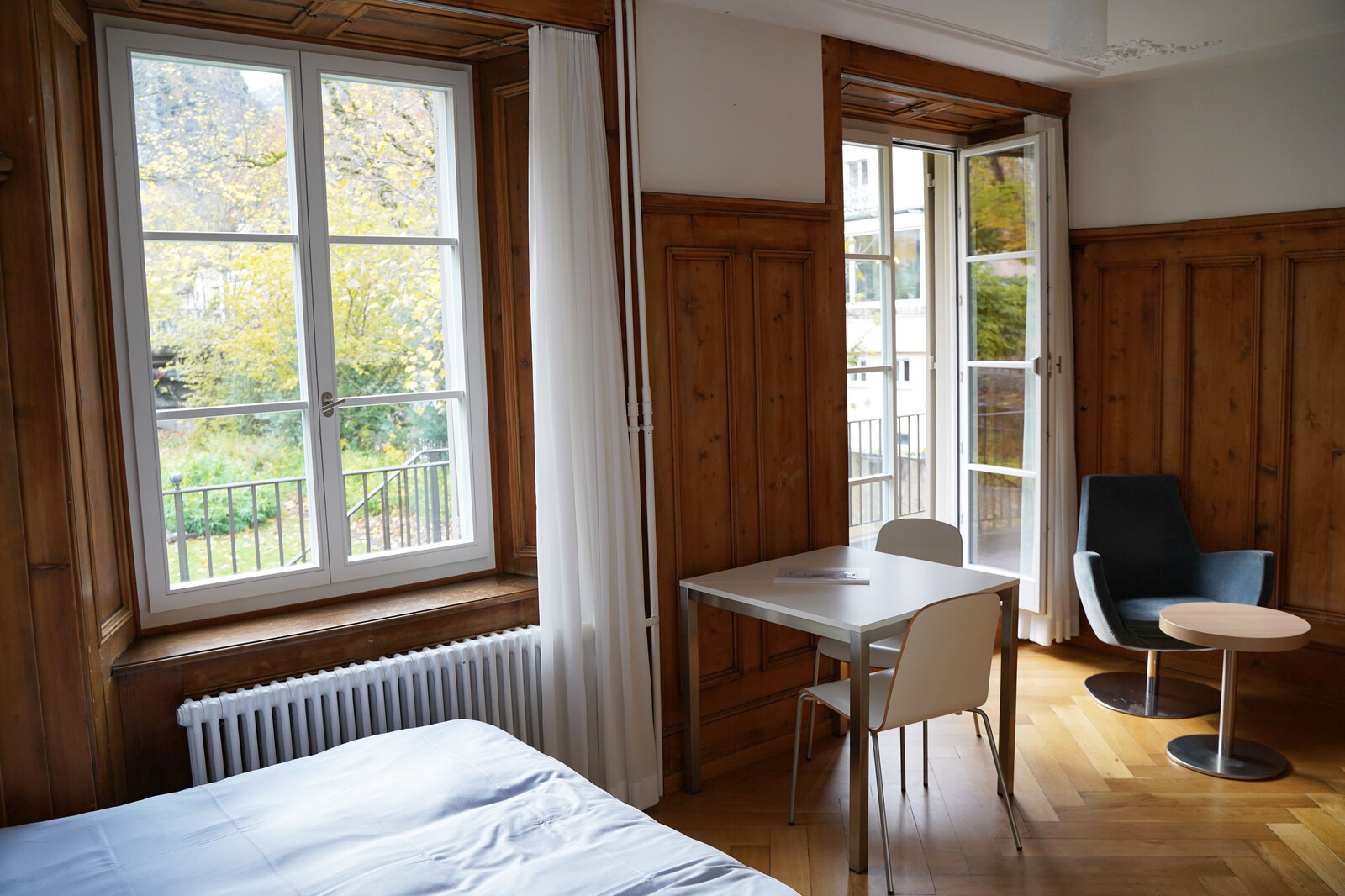 The door to the garden is open in the studio of the Sarona staff house in the Grand Resort Bad Ragaz. The Grand Resort is a star hotel in Switzerland.